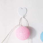 Three Heart-Shaped Hooks with Strong Adhesive,Perfect for Hanging Decorations in Kitch close-up view