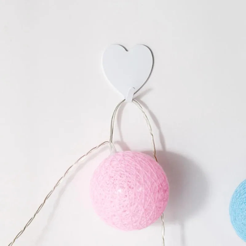 Three Heart-Shaped Hooks with Strong Adhesive,Perfect for Hanging Decorations in Kitch close-up view