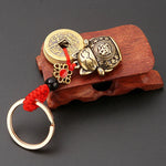 Brass Lucky Cat Keychain with Five Emperor Coins close-up view
